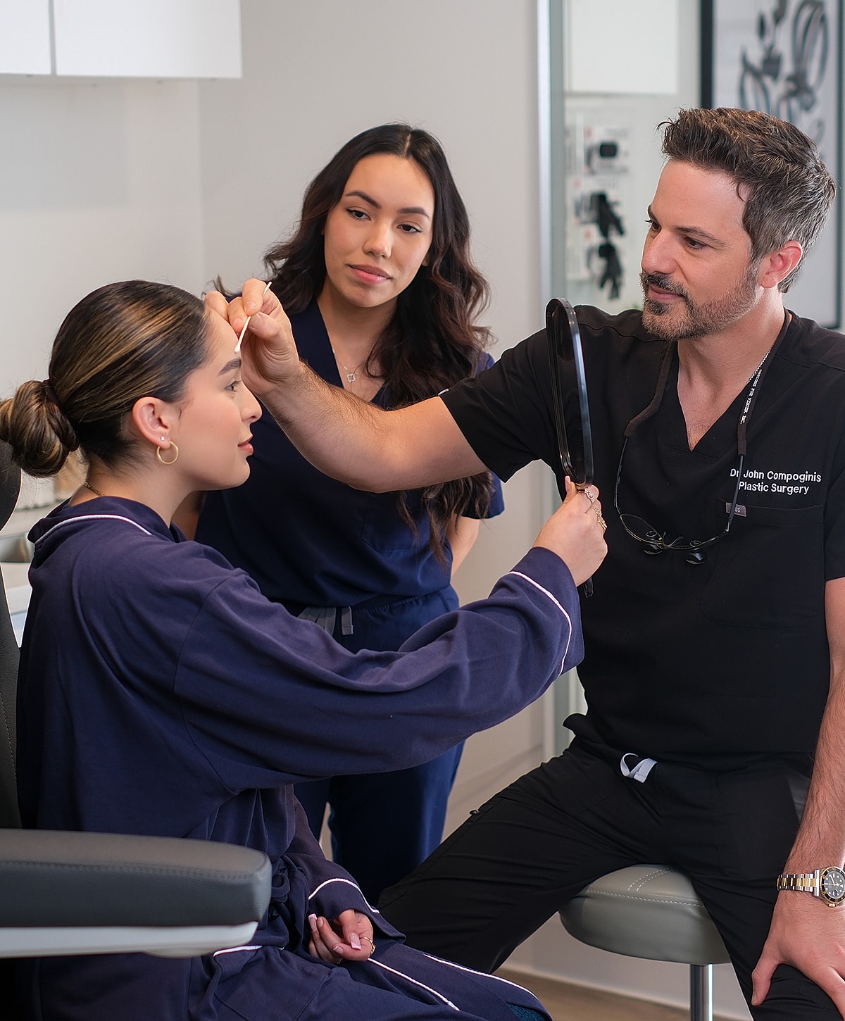 Plastic surgeon consulting with patients in clinic