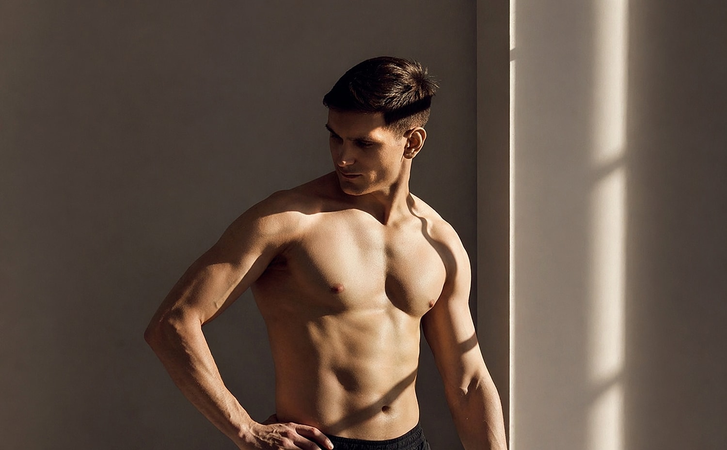 Muscular man posing in soft natural light.