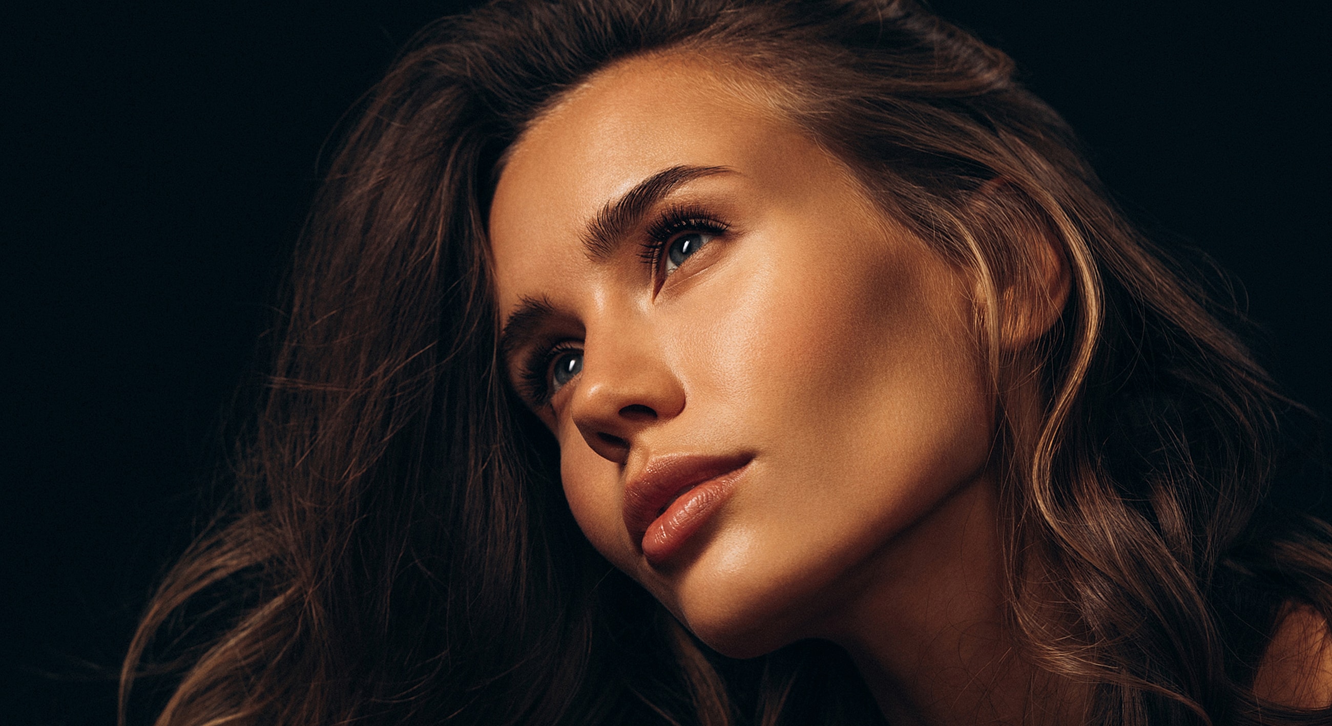 Close-up of a woman with flowing hair.