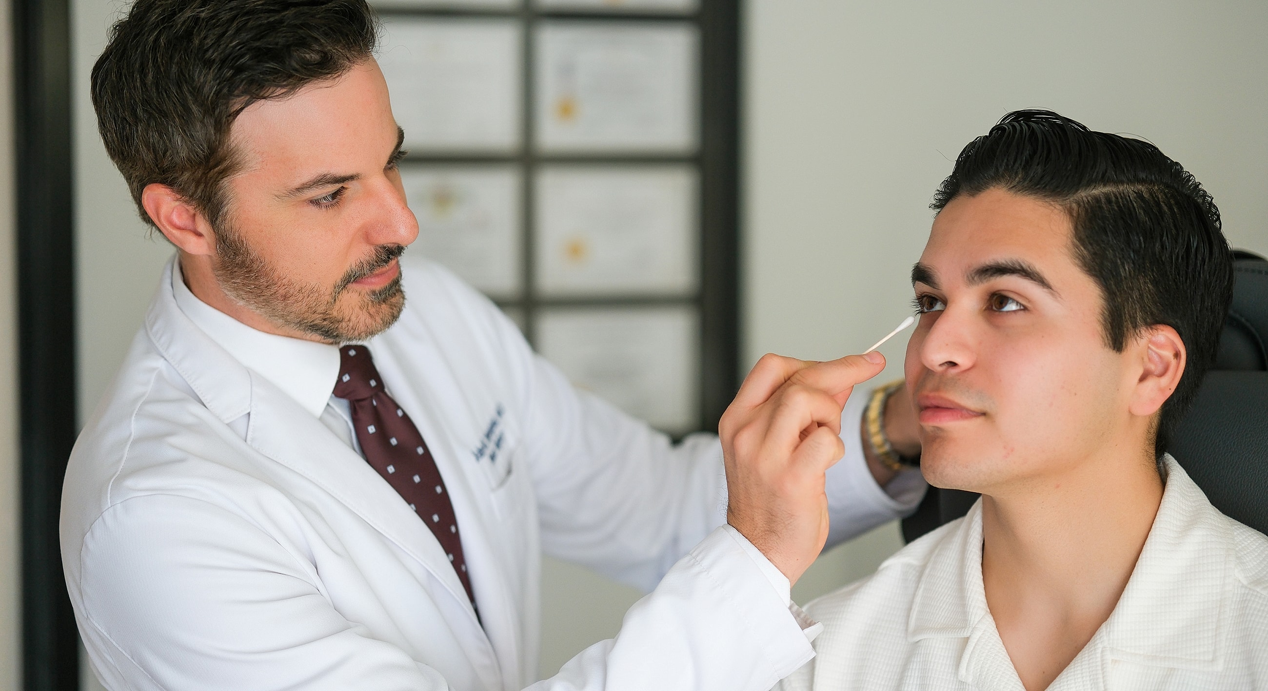 Doctor examining patient with a cotton swab.