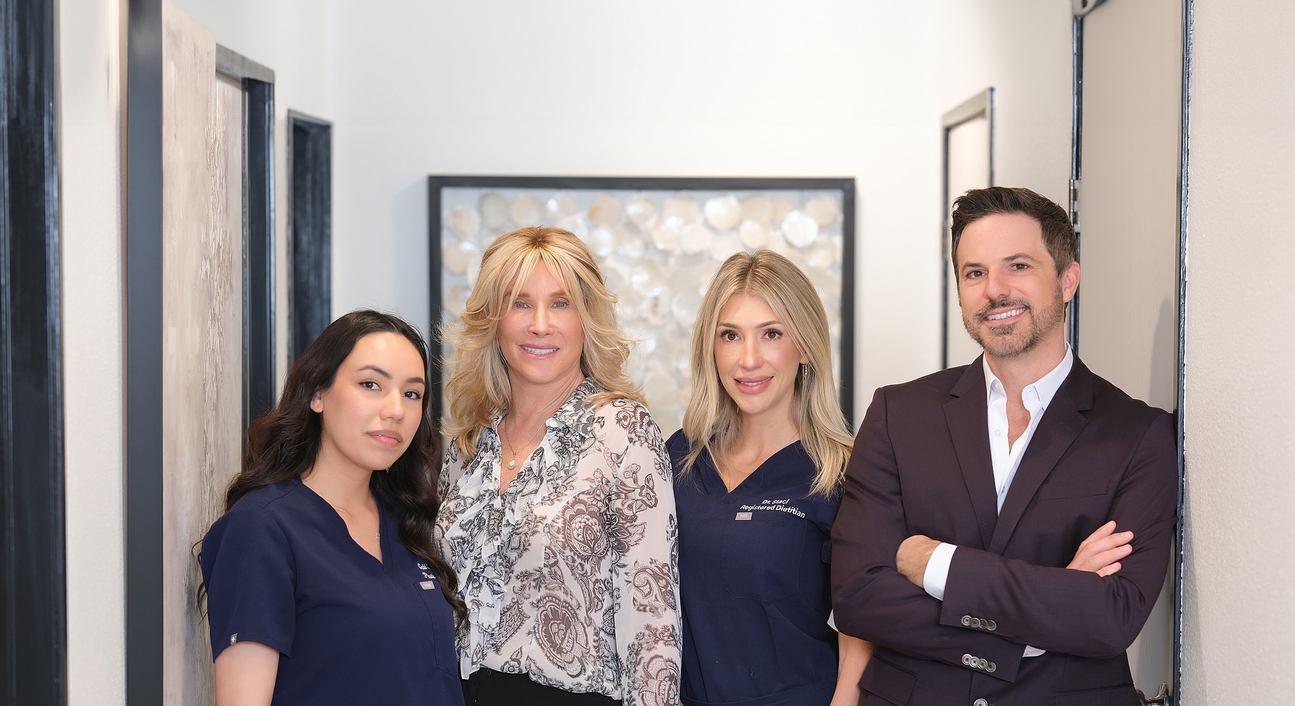 Healthcare team posing in a hallway setting.